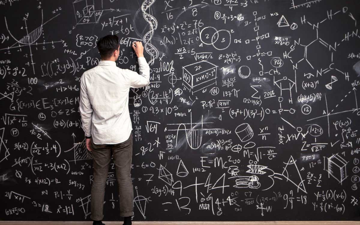 A person looking at a blackboard Description automatically generated with low confidence