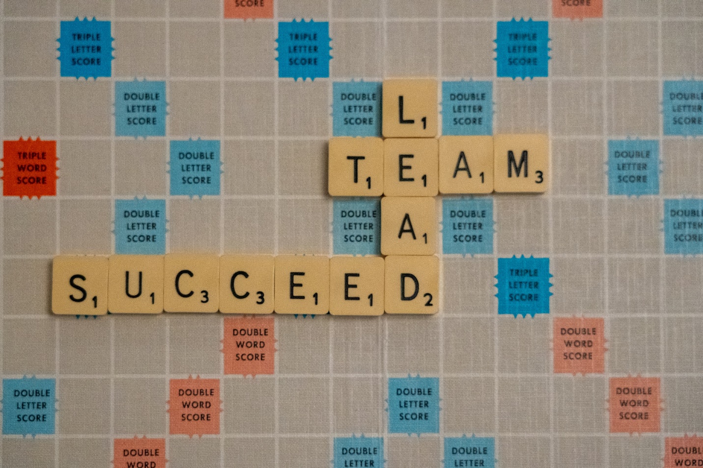 A group of scrabble tiles spelling words Description automatically generated