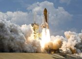 A rocket taking off from a launchpad Description automatically generated with low confidence